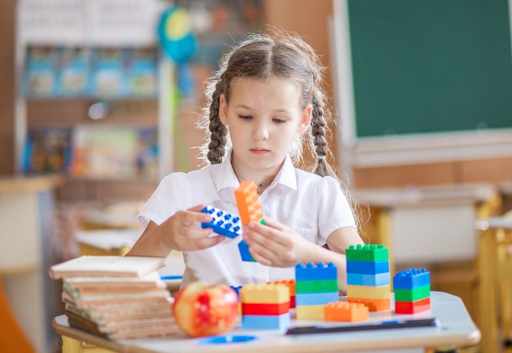 before and after school programs girl playing with blocks
